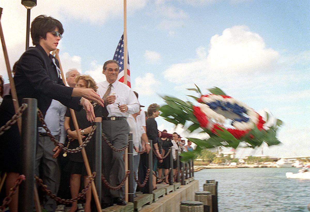Mirta Mendez, sister of fallen brother to the rescue carlos Costa, throws a reef in Biscayne Bay after a ceremony commemorating the first anniversary of the shoot down over Cuban waters.