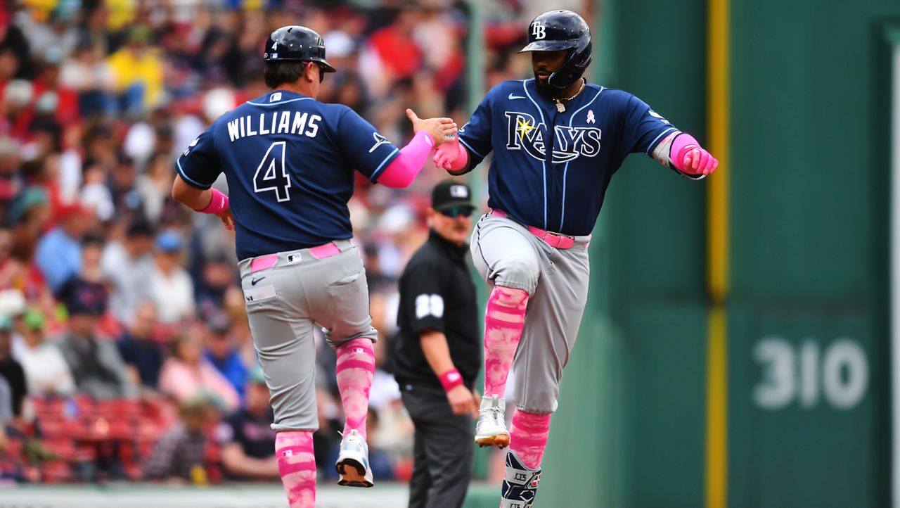 Tampa Bay Rays' Junior Caminero, right, celebrates after his home run with third base coach Brady Williams (4) as he runs the bases toward home in the first inning of a baseball game against the Boston Red Sox, Sunday, May 10, 2026, in Boston. (AP Photo/Steven Senne)