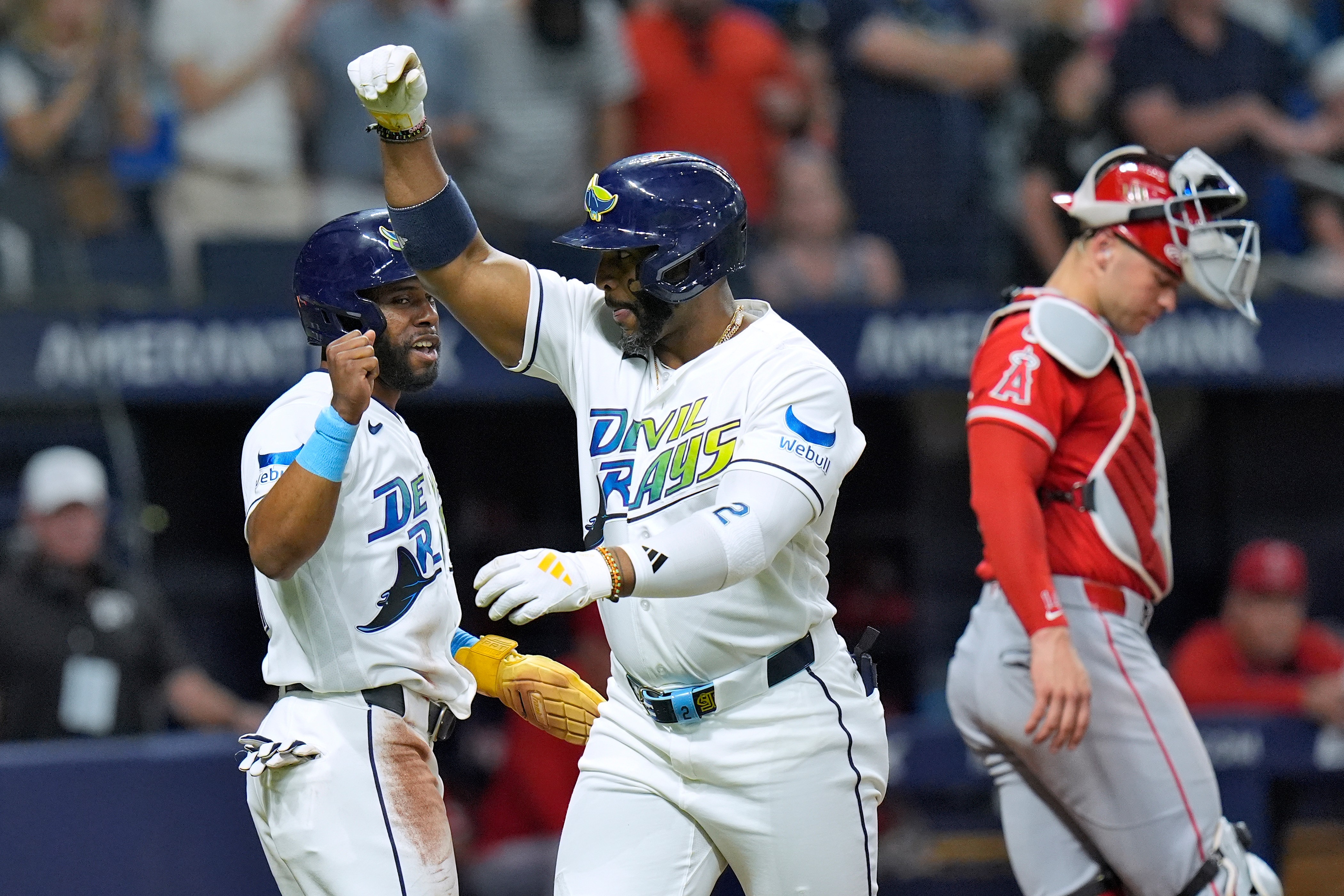 The Tampa Bay Rays’ Yandy DÃaz, middle, celebrates after hitting...