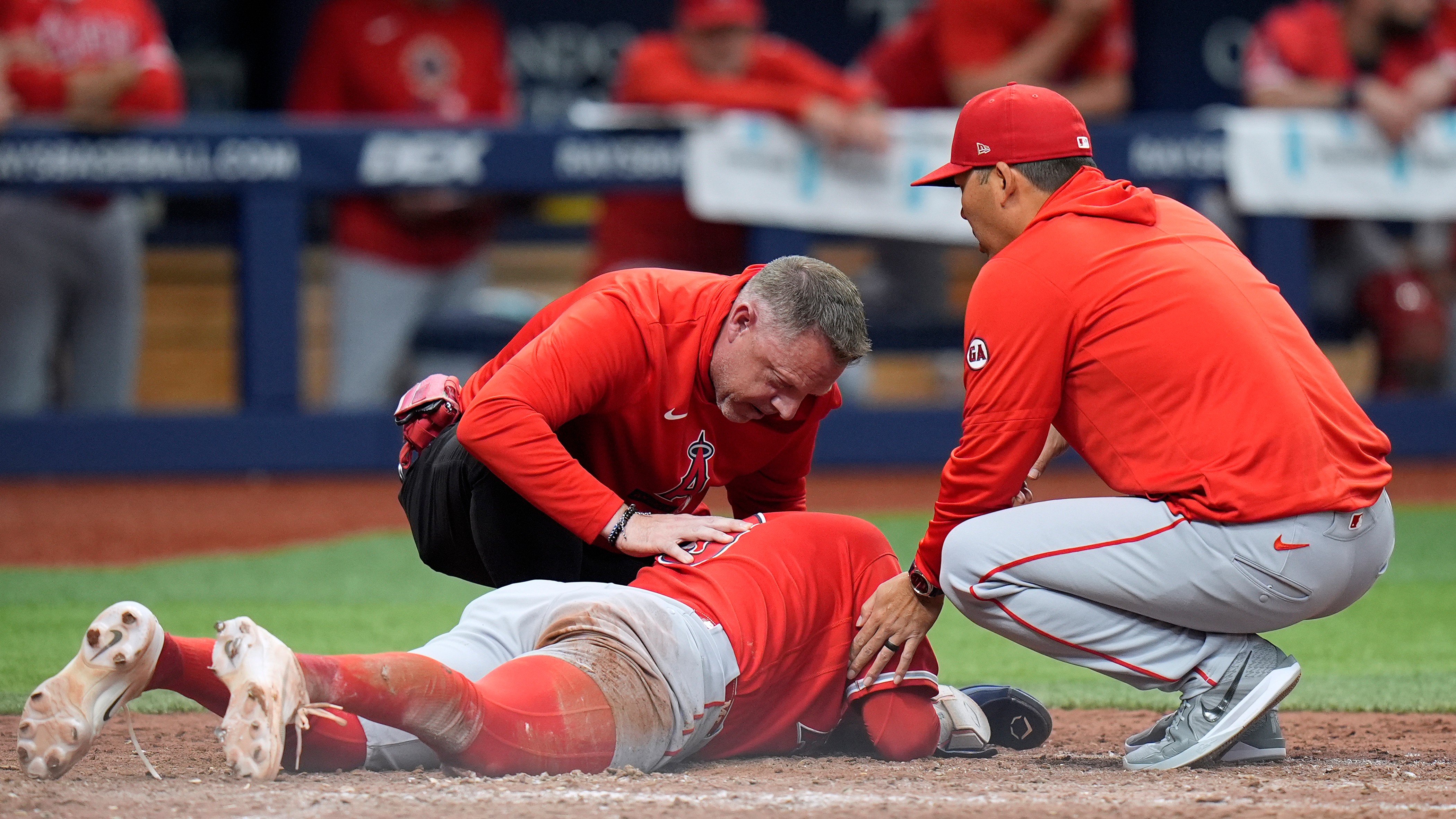 An Angels trainer and manager Kurt Suzuki, right, check on...