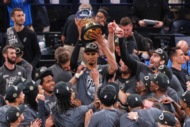 San Antonio Spurs center Victor Wembanyama holds up the Oscar Robertson Trophy after defeating the Oklahoma City Thunder in the Western Conference Finals on Saturday night. (AP Photo/Nate Billings)