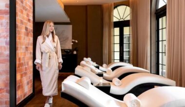 photo of a woman in a robe walking past treatment beds in a spa