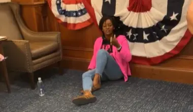 Rep. Angie Nixon sitting on the floor