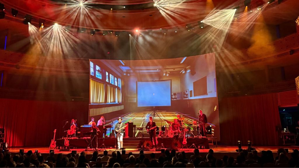 Photo of Belle and Sebastian performing on stage in Miami.