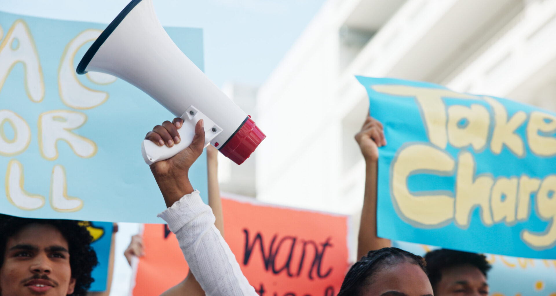 Strike, people and hands with megaphone in city for inflation, human rights and cost of living. Speaker, community and group in protest with bullhorn for rally, justice or higher wages for change