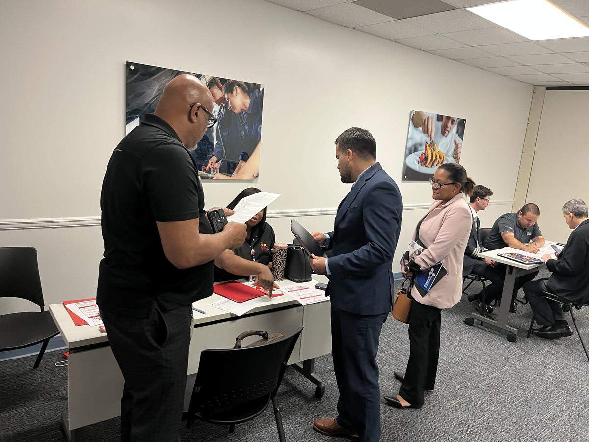 Jobseekers talk to recruiters at CareerSource Broward’s mini job fair.