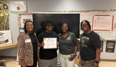 Dekarius Carswell receives his scholarship certificate.