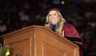 Sara Blakely looks out over the graduating class while speaking from the stage.