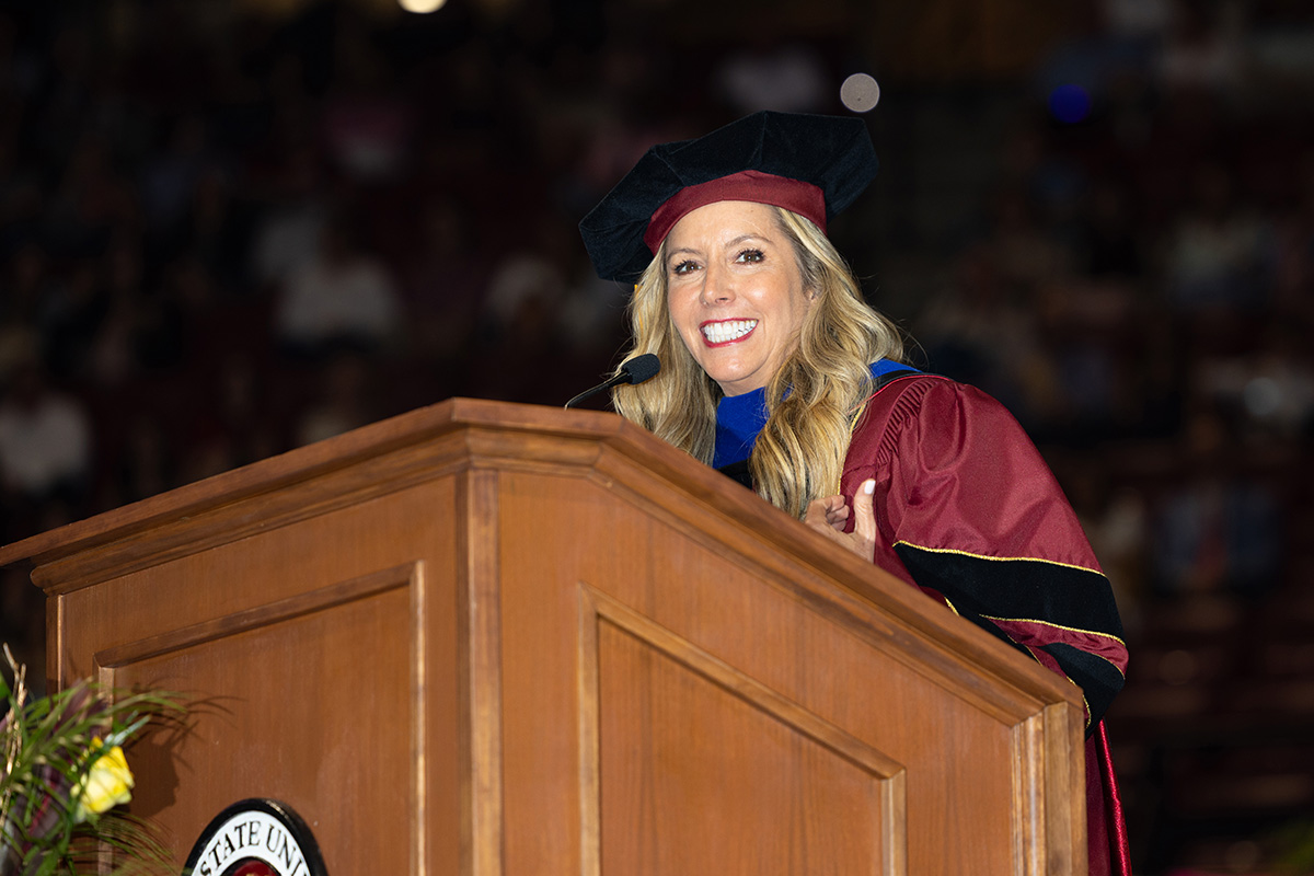 Sara Blakely looks out over the graduating class while speaking from the stage.