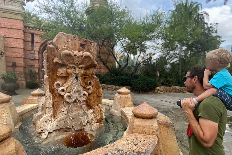 Father and son talk to Mystic Fountain at Islands of Adventure - Photo by Dani Meyering
