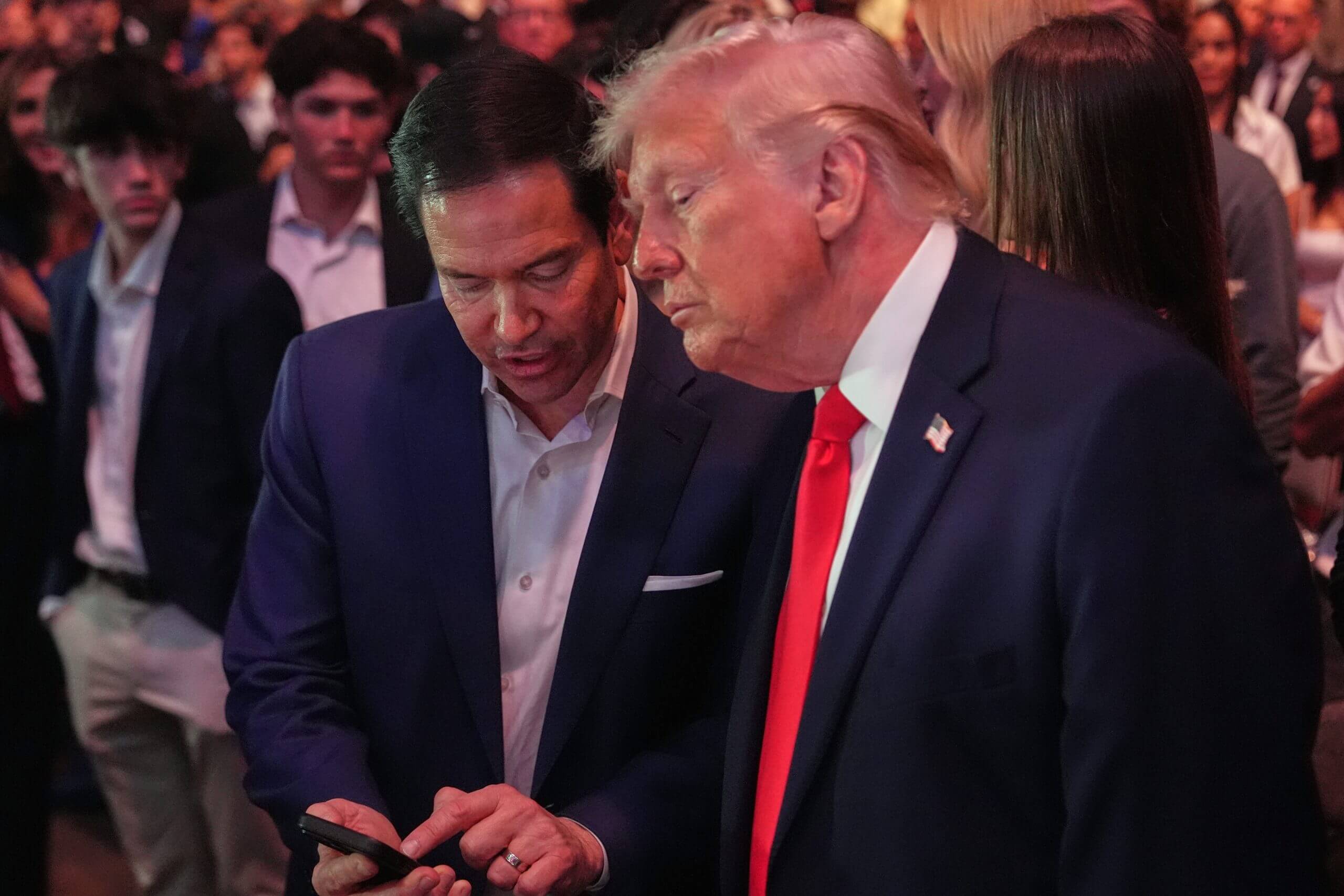 President Donald Trump speaks with Secretary of State Marco Rubio during UFC 327 at Kaseya Center in April