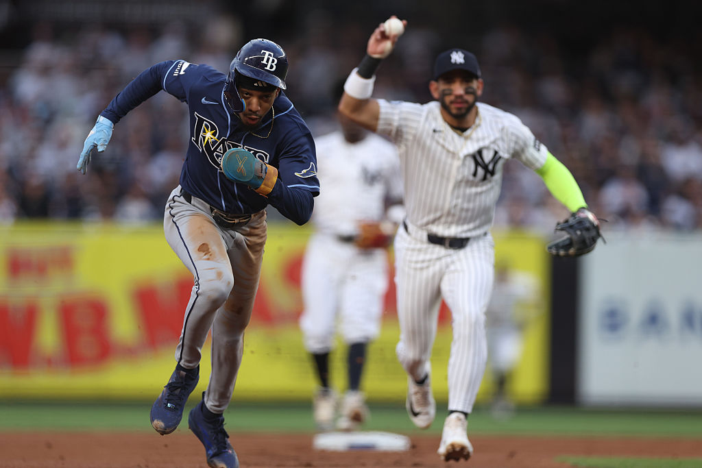 NEW YORK, NEW YORK - MAY 22: Chandler Simpson #14 of the Tampa Bay Rays runs while being chased by José Caballero #72 of the New York Yankees during the first inning at Yankee Stadium on May 22, 2026 in the Bronx borough of New York City. (Photo by Ishika Samant/Getty Images)