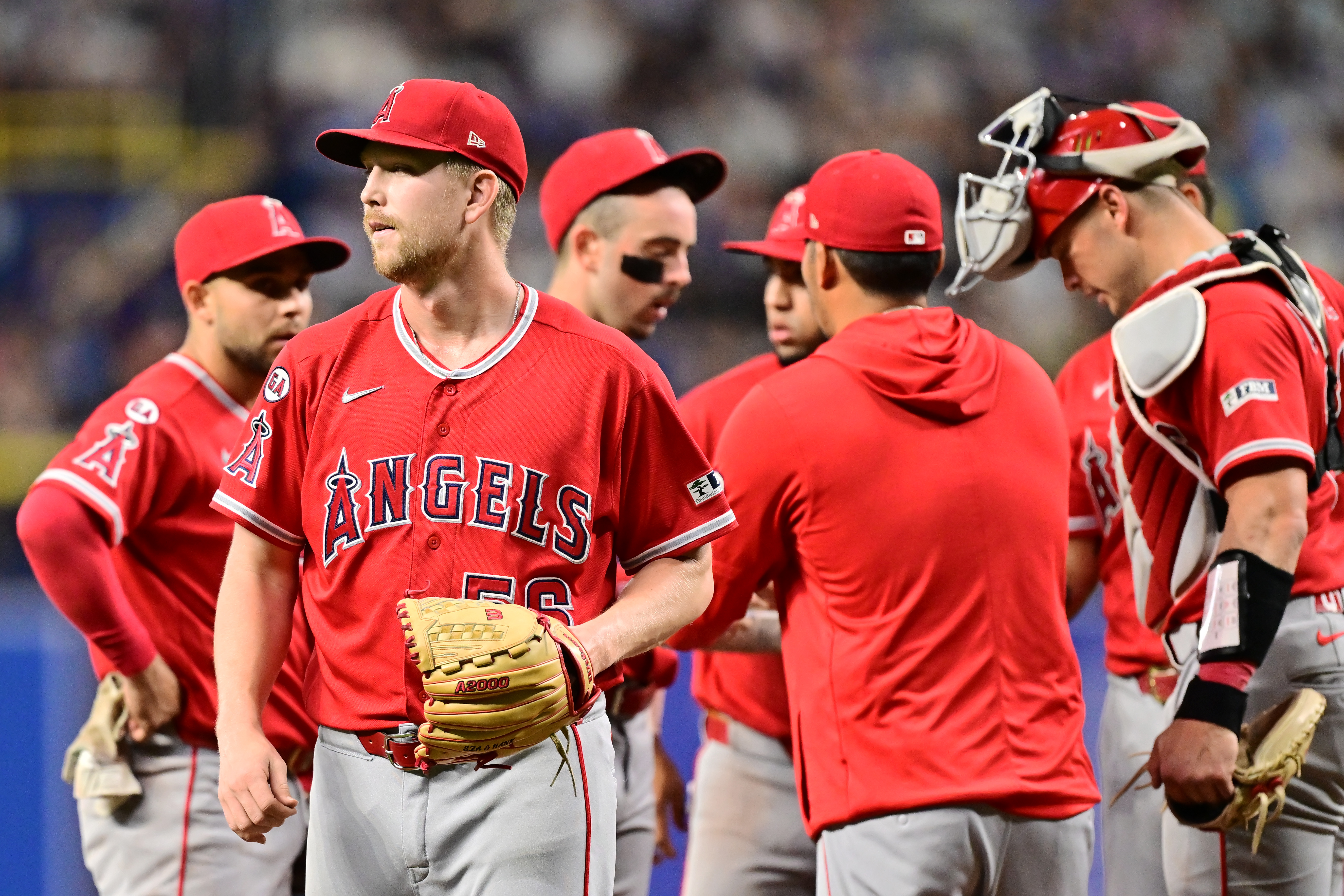 Angels relief pitcher Ryan Zeferjahn, left, walks off the mound...