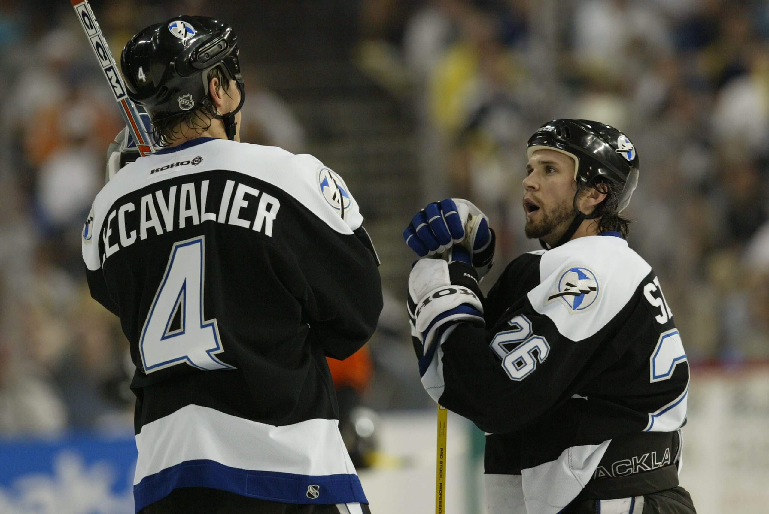 Lecavalier and St. Louis talk on the ice in a game during their 2004 Stanley Cup season.