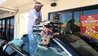 Photo of a DJ in Miami outside La Granja Restaurant inside a convertible BMW.