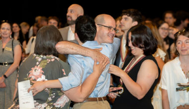 A father embraces his son during the honors medallion ceremony