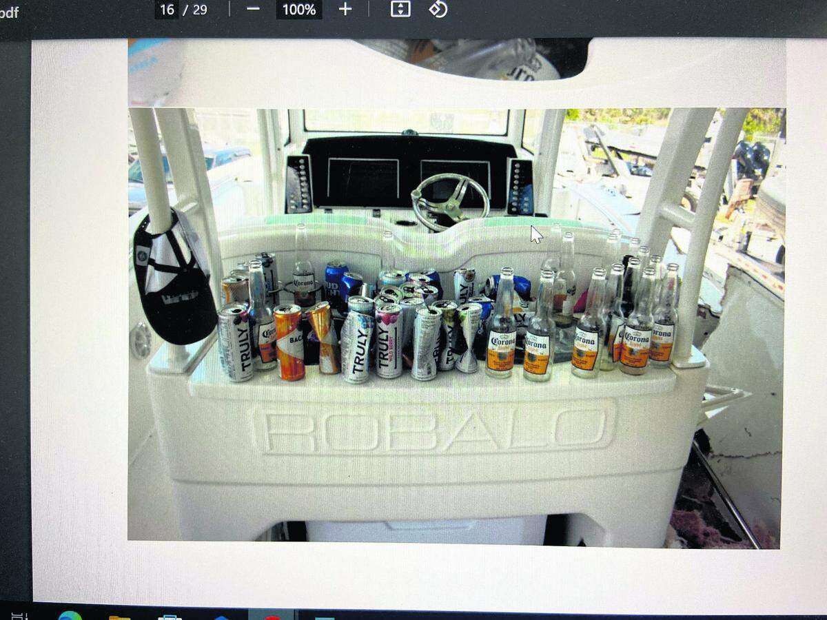 Empty beer and other alcoholic beverage bottles and cans are lined up behind the cockpit of George Pino’s 29-foot Robalo boat on Sept. 5, 2022, the day after the crash.