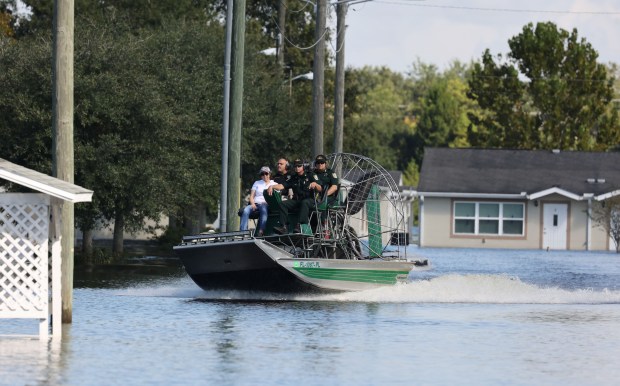 Osceola Sheriff Marcos Lopez and Attorney General Ashley Moody get an airboat tour of the flooded Good Samaritan Society Kissimmee Village, on Tuesday, October 4, 2022. (Ricardo Ramirez Buxeda/ Orlando Sentinel)