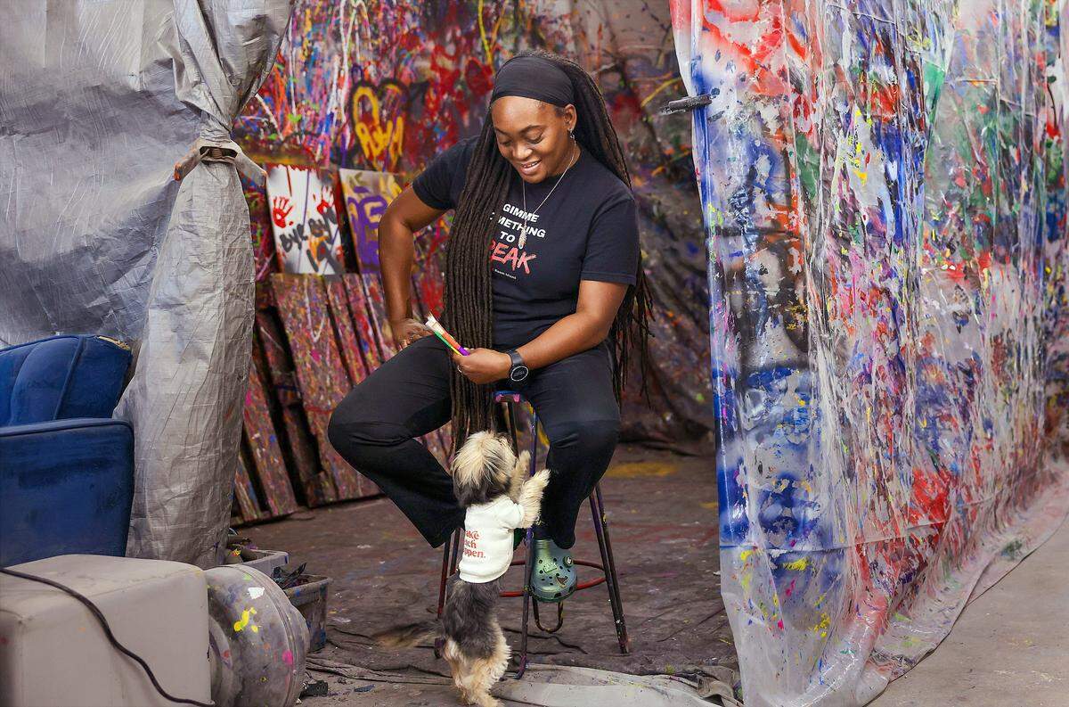 Christina Brown, 40, owner of Break Room Miami, is called by her dog while searching for a ball, Thursday, May 7, 2026, in Miami.