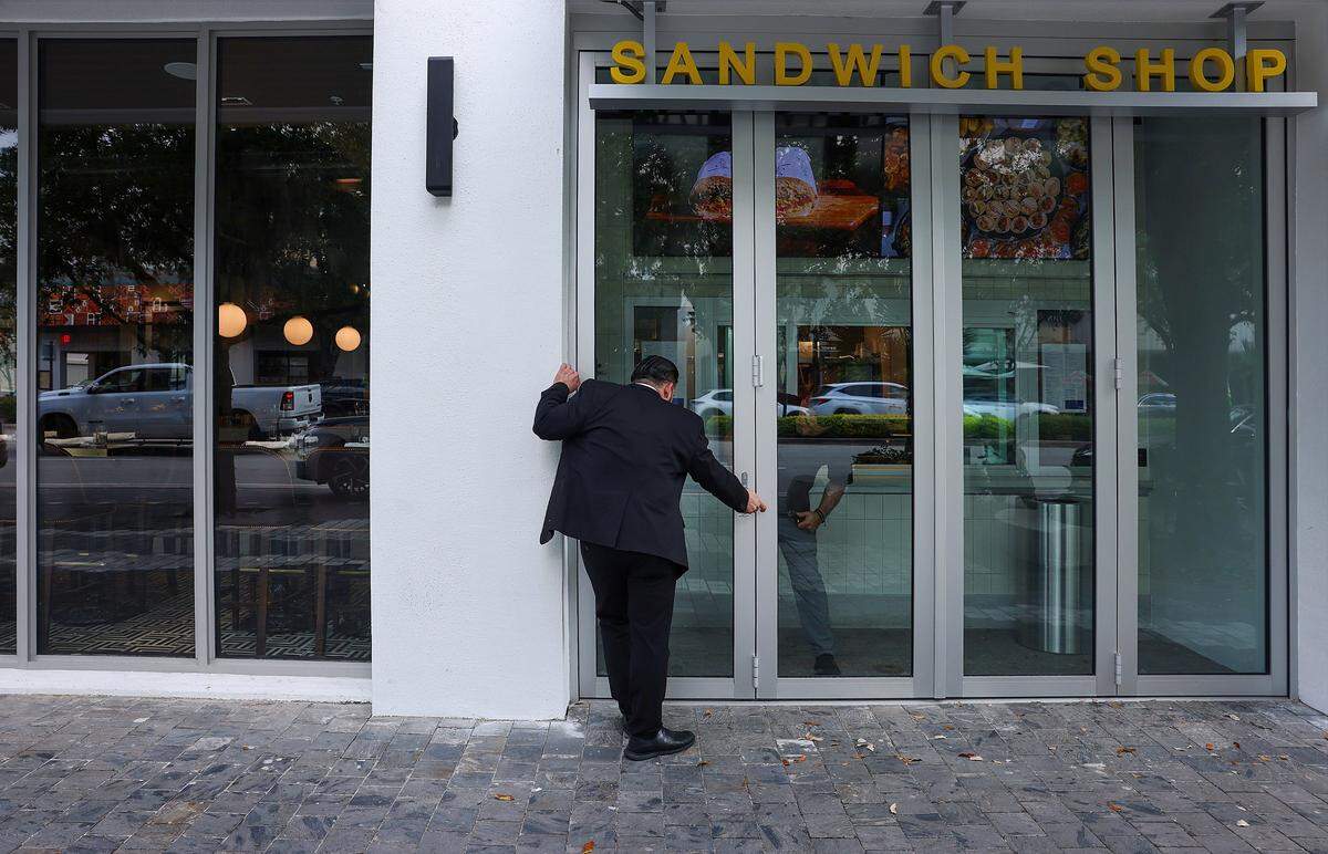 Buccan staffers prepares the windows and doors as they prepare for “friends and family” opening at the new restaurant in Coral Gables, ahead of its official opening on Tuesday, May 19, 2026.