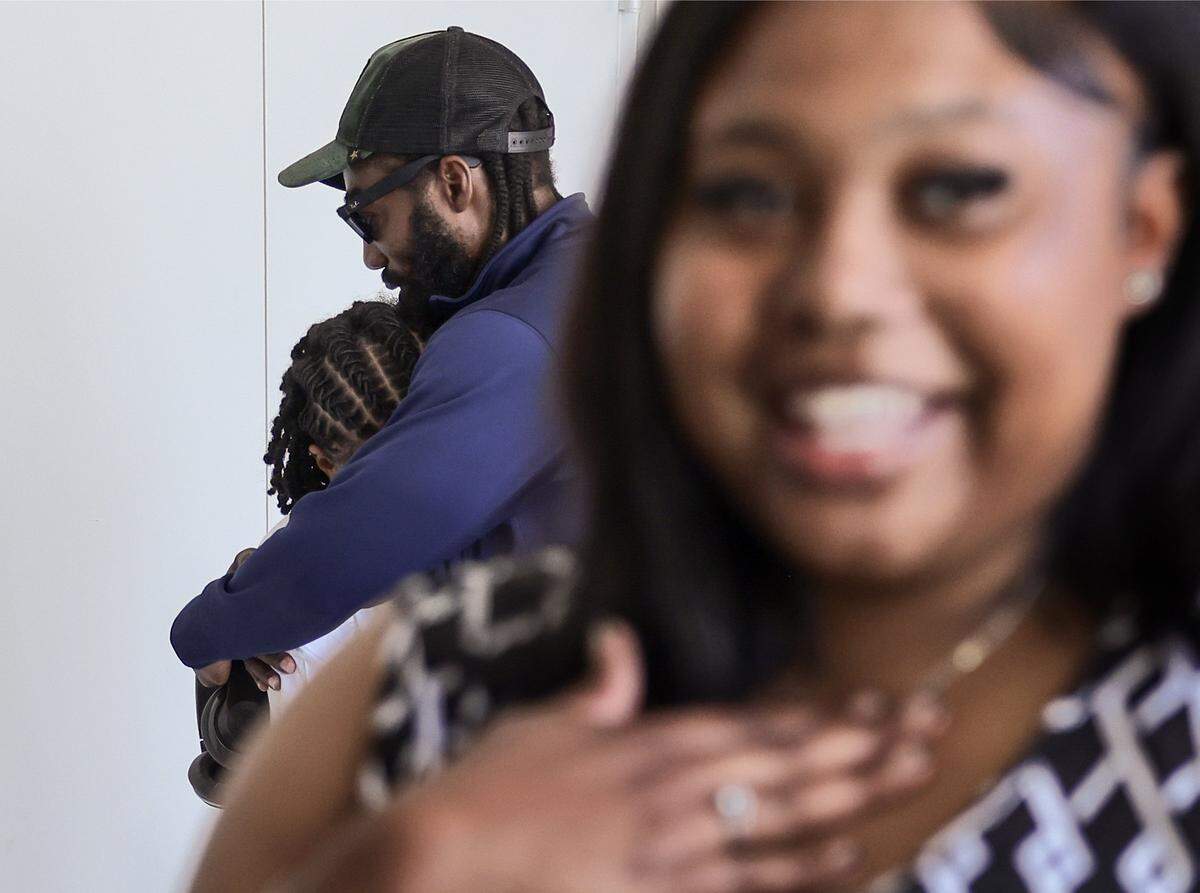 Yaz'Nique Jean Francois, left, is embraced by her uncle Antwan Ezell, as Patricia Smith is interviewed after they both were awarded scholarships during the Booker T. Washington Senior High School Class of 2026 Senior Awards Ceremony on Tuesday, May 19, 2026, in Miami, Florida.