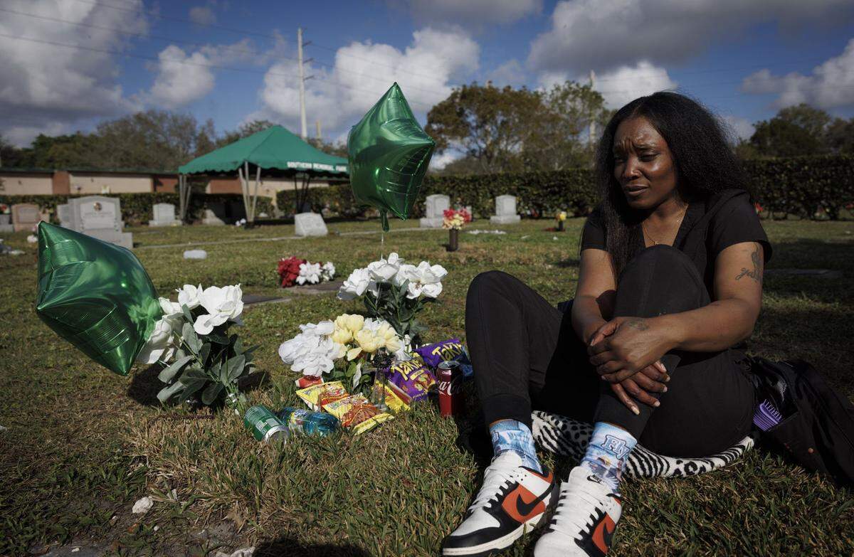 Nathalie Lollar visits her son’s grave just months after his passing after getting off the night shift on Friday, Feb. 7, 2025, at Southern Memorial Park in North Miami, Fla.