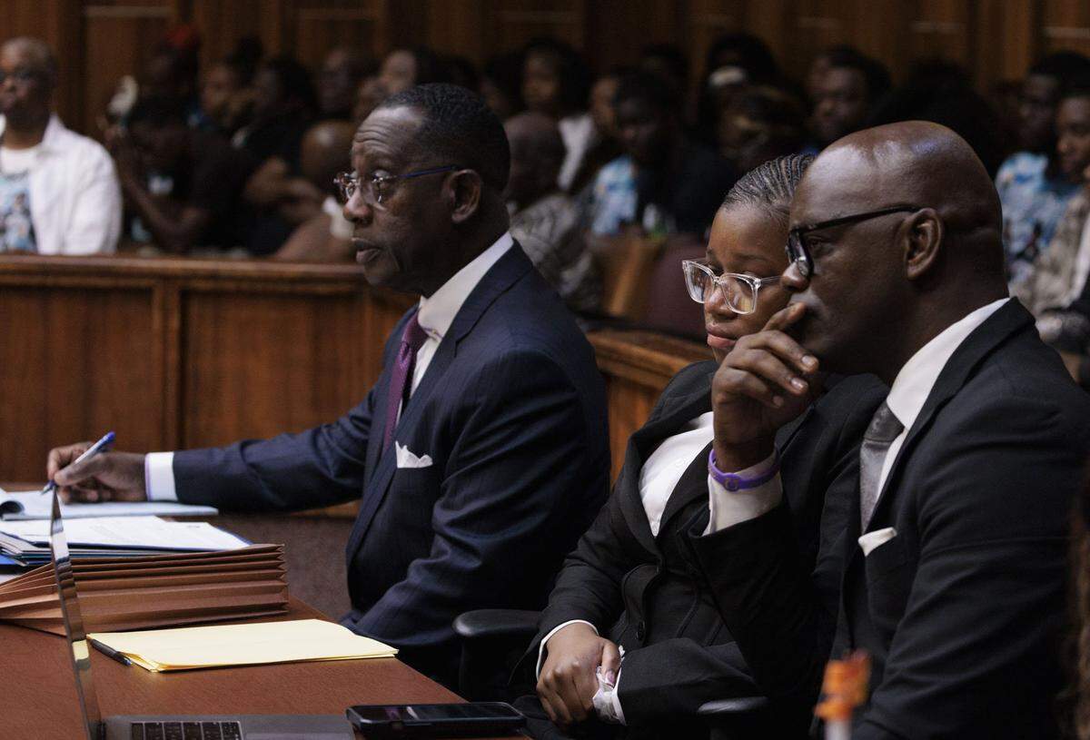Jahara Malik, now 18, sits with her defense team at her sentencing hearing in a court room filled surrounded by the victims family after pleading guilty to a manslaughter charge from the fatal stabbing of Yahkeim Lollar, a beloved football player at Miami Northwestern Senior High, in court Tuesday, May 5, 2026, at Richard E. Gerstein Justice Building in downtown Miami, Fla.