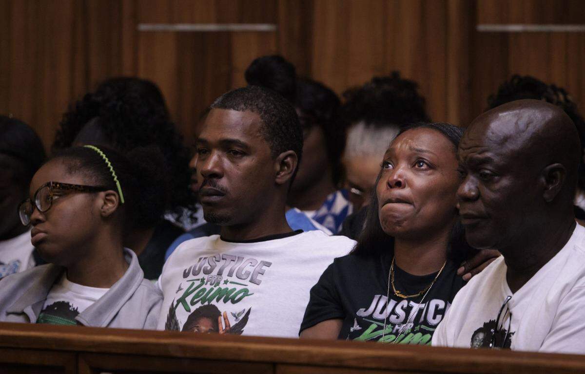 Nathalie Lollar, mother of victim Yahkeim “Keimo” Lollar, second from the right, and his father, second from left, sit with family at the sentencing of Jahara Malik, not pictured, after pleading guilty to a manslaughter charge from the fatal stabbing of Lollar's son, Yahkeim Lollar, a beloved football player at Miami Northwestern Senior High, in court Tuesday, May 5, 2026, at Richard E. Gerstein Justice Building in downtown Miami, Fla.