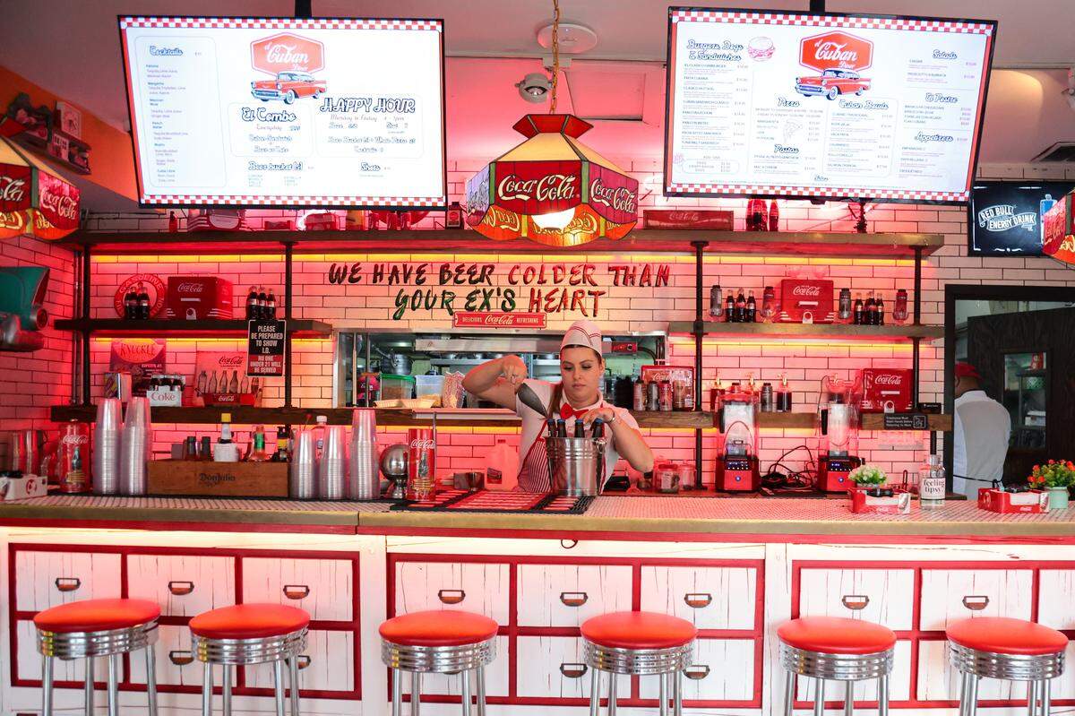 Sophia Stapleton, who works as a restaurant server, adds ice cubes to a bucket with cold beers during her shift at El Cuban Diner at 1620 SW Eighth St., in Miami, Fla., on Tuesday, Nov. 4, 2025.
