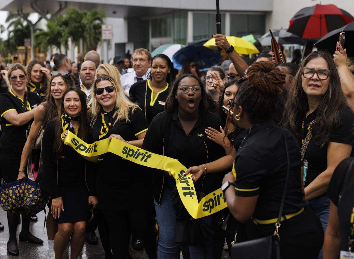 Former Spirit Airlines employees, who were recently left without jobs as the airlines closed Saturday, gather across from corporate headquarters on Monday, May 4, 2026, in Dania Beach, Fla. “Everybody that showing up is a good representation of who we are as a company, not just the flight attendants but it's dispatch operations, ramp workers, everyone is here,” said Leanne Hugg. About 300 people came out to support each other.