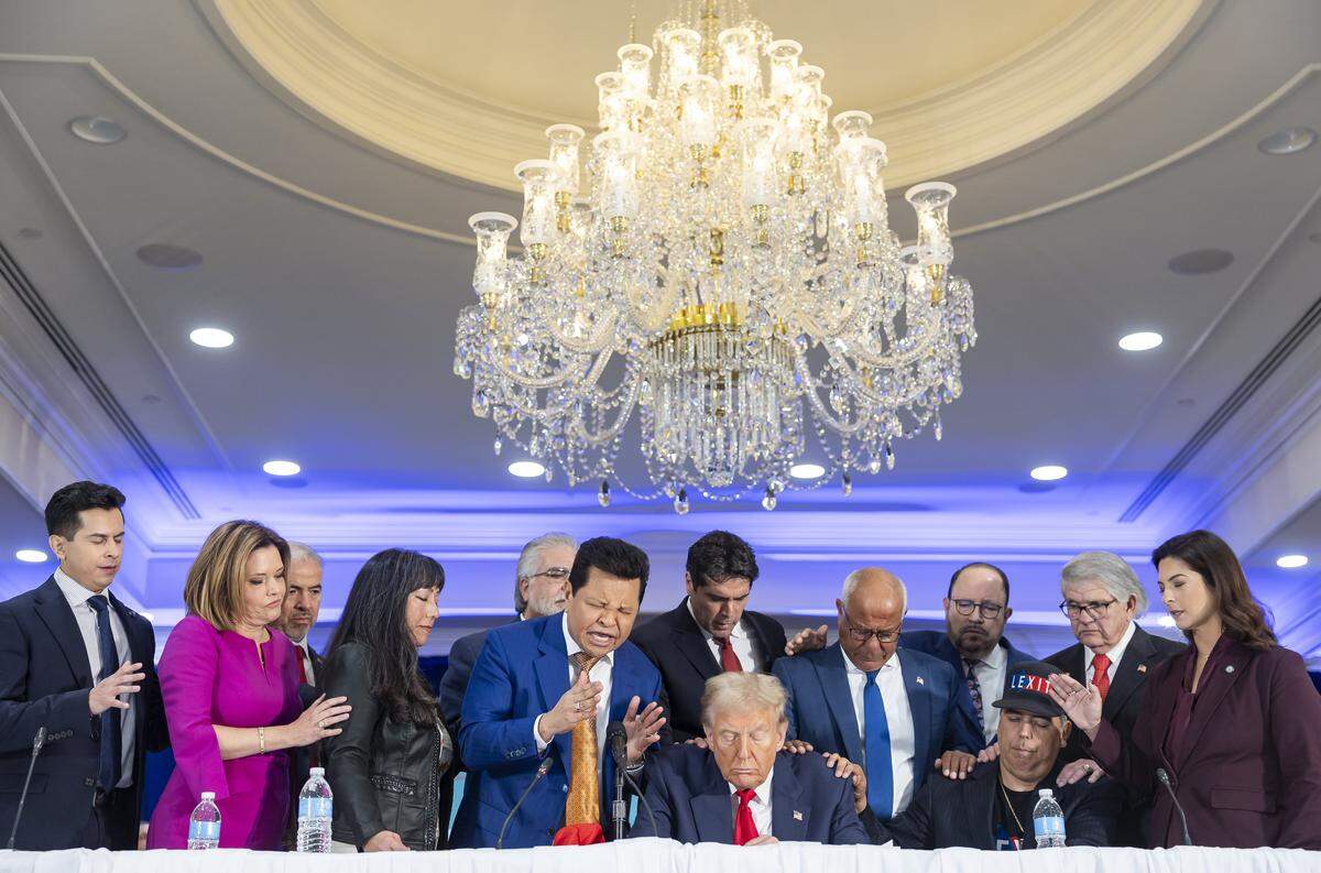 Miami megachurch pastor Guillermo Maldonado, center-left, leads a prayer for President Donald Trump during a roundtable discussion with local Latino leaders at Trump National Doral Miami on Tuesday, Oct. 22, 2024, in Doral.