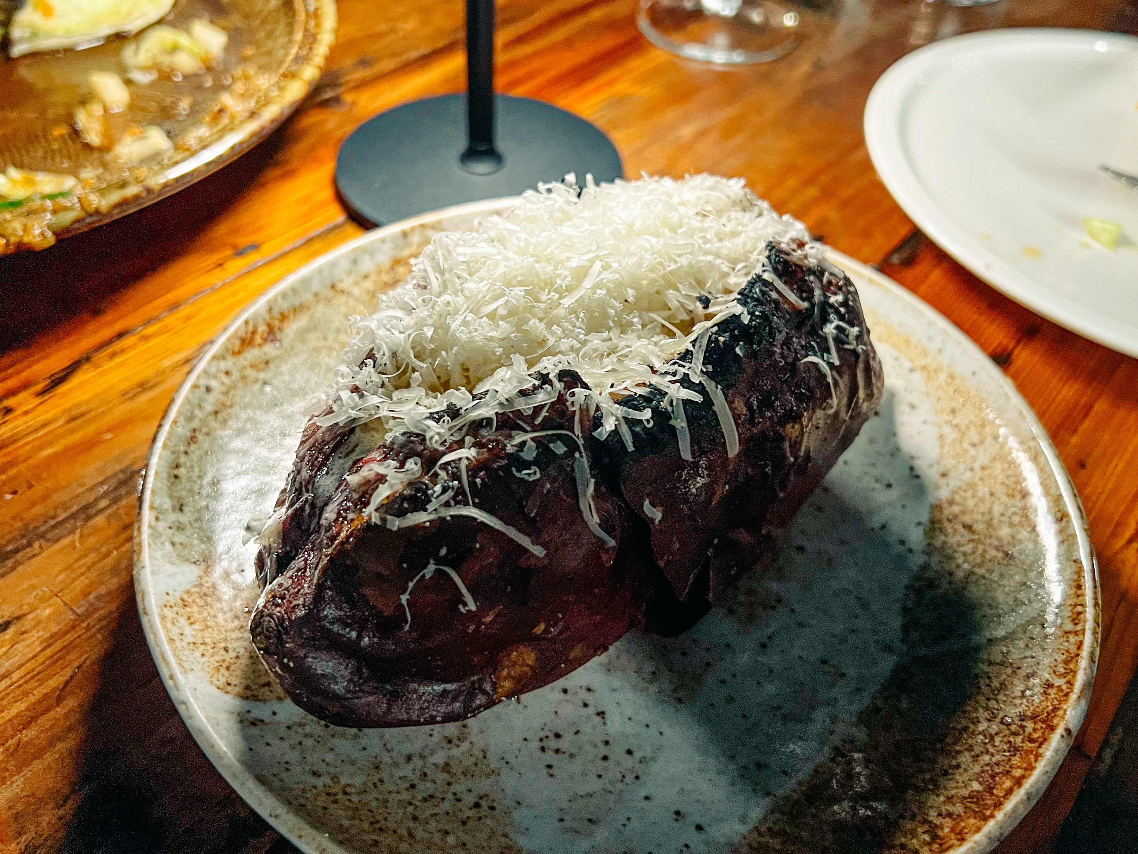 A sweet potato covered in cheese.