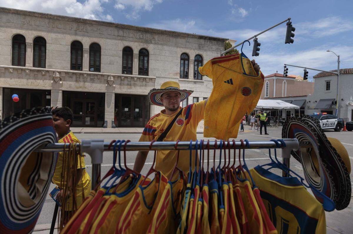 Ryan Gomez sells shirts as people celebrate across from the Columbian Consulate after voting in the streets on Sunday, May 31, 2026, in Coral Gables, Fla.