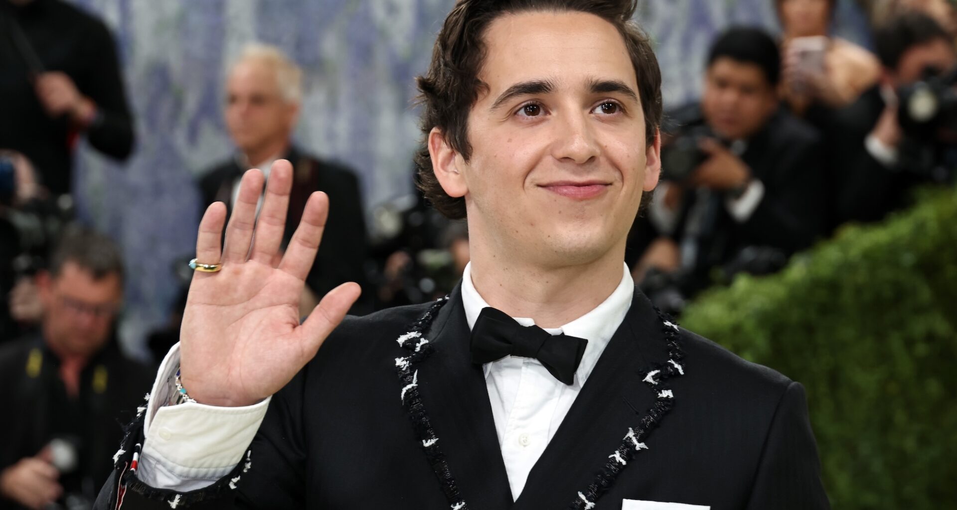 photo of Marcello Hernandez waving to photographers on the Met Gala red carpet