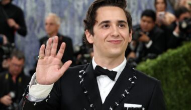 photo of Marcello Hernandez waving to photographers on the Met Gala red carpet
