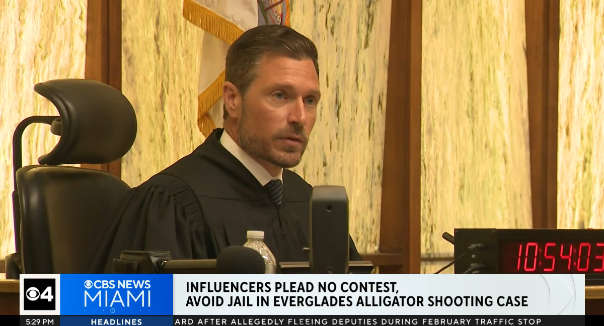 A screenshot of news broadcast showing a judge seated in a courtroom.