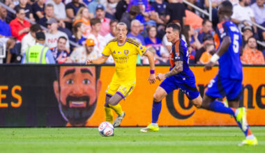 Image of Griffin Dorsey dribbling up the side past two FC Cincinnati defenders.