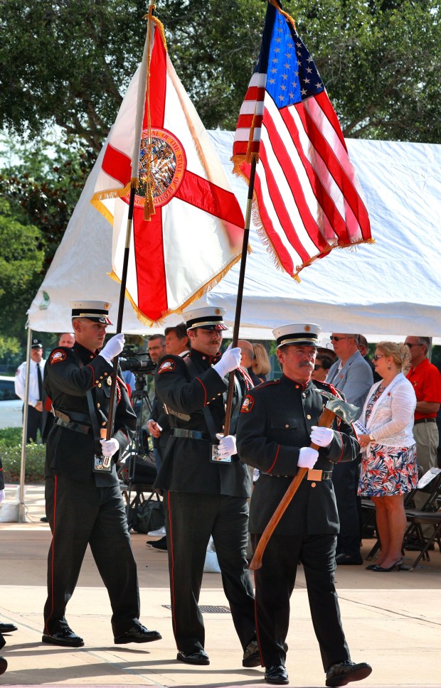 Seminole County Fire Department Honor Guard members present the flags of Florida and the U.S. during a Memorial Day Remembrance Ceremony at the Seminole County Heroes Memorial in Sanford, Friday, May 27, 2022. The ceremony kicked off the Memorial Day weekend, with a full slate of memorial events scheduled across Central Florida through the federal holiday on Monday. (Joe Burbank/Orlando Sentinel)