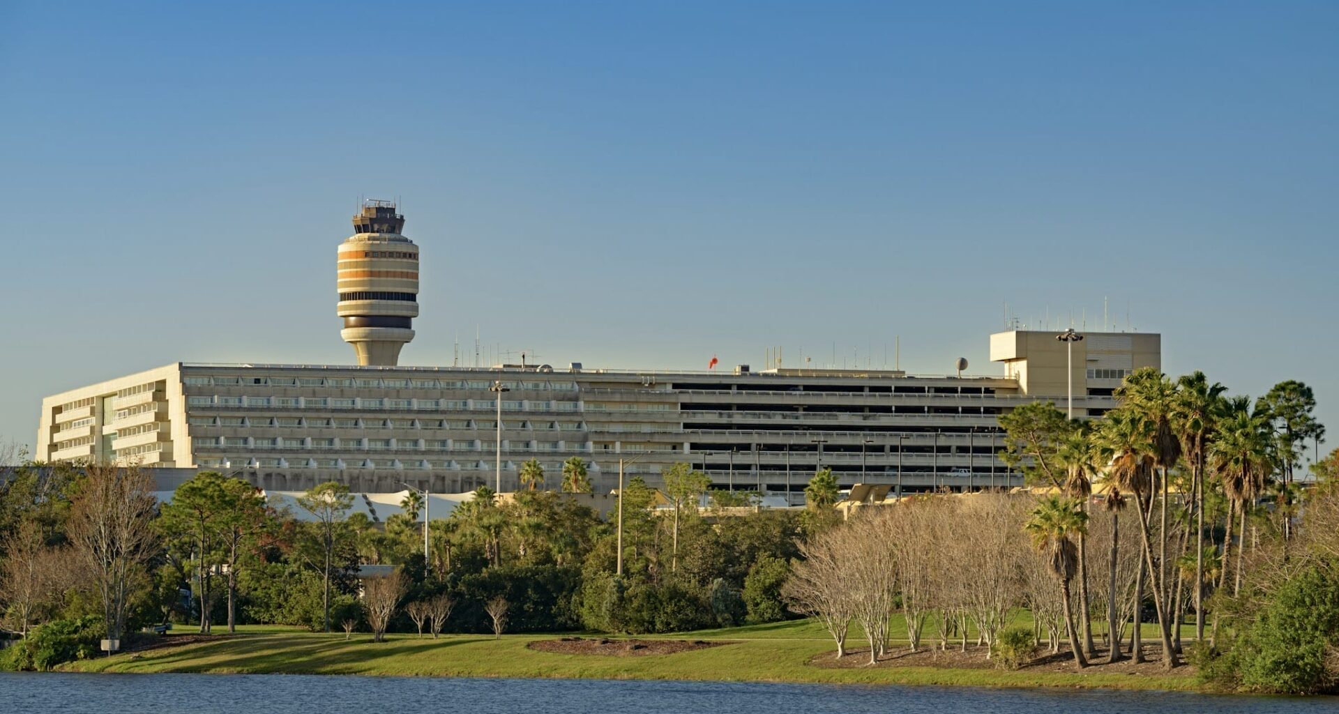 Orlando International Airport buildings in front of a lake.