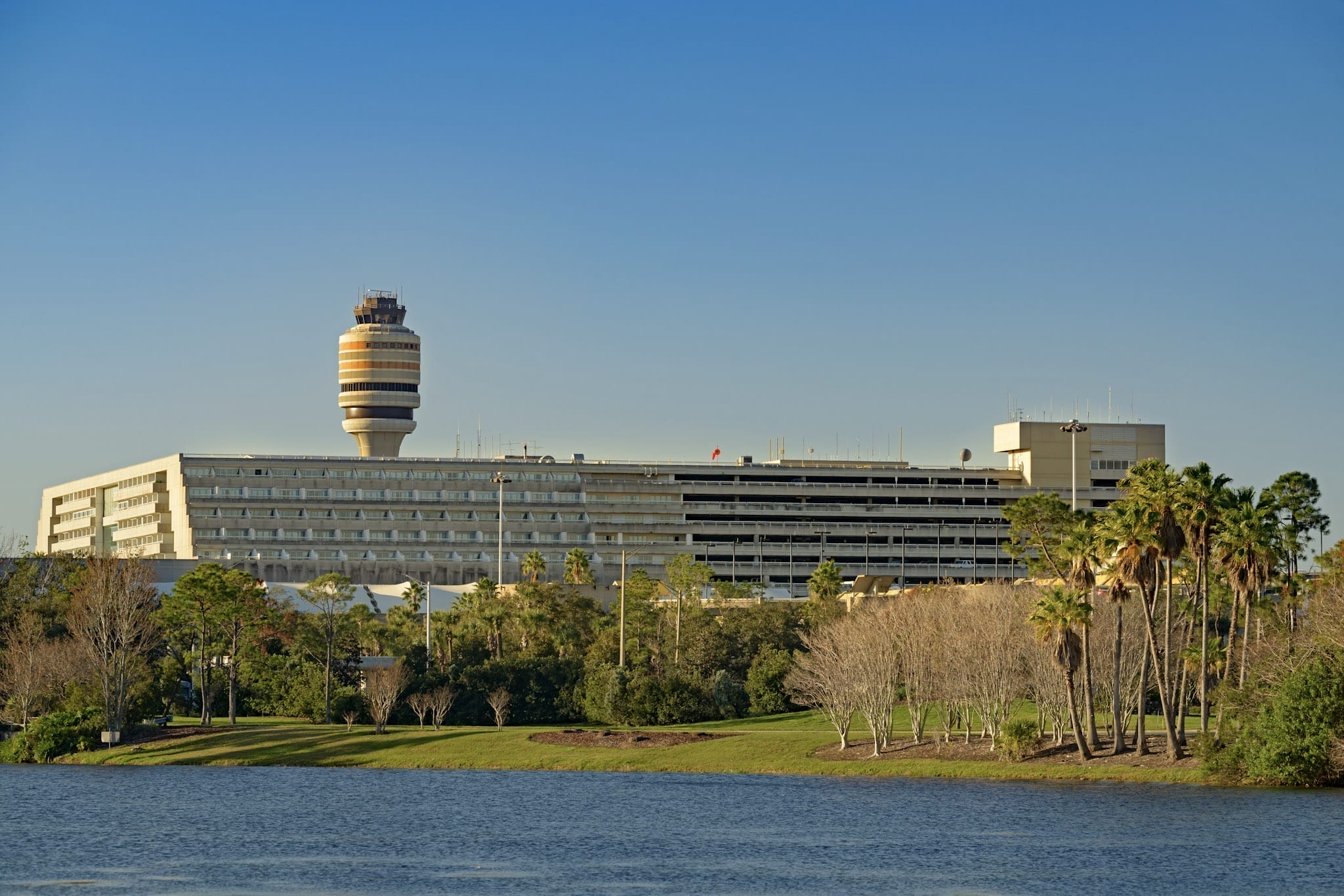 Orlando International Airport buildings in front of a lake.