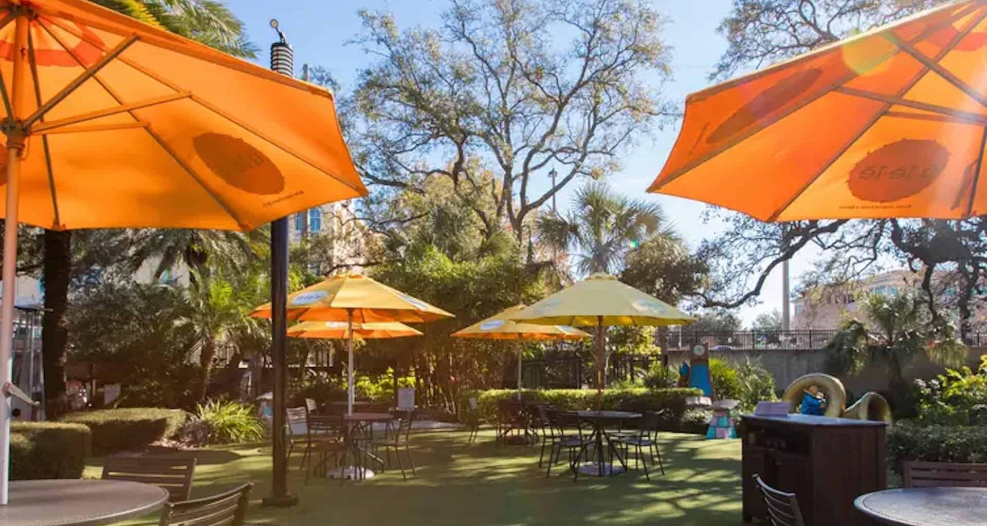 outdoor dining area at a restaurant. Yellow umbrellas are arranged over tables