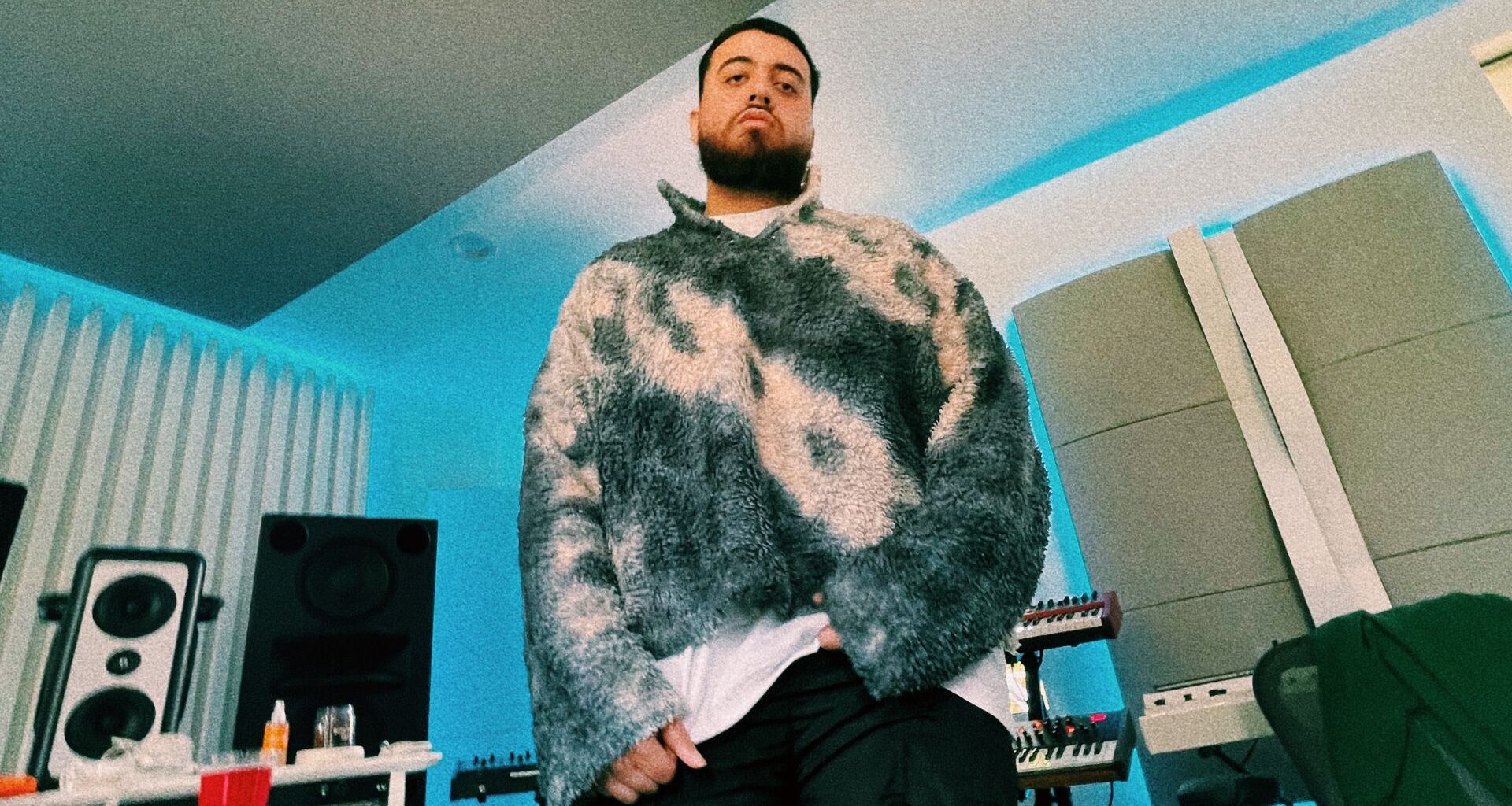 Photo of a man standing in a small studio.