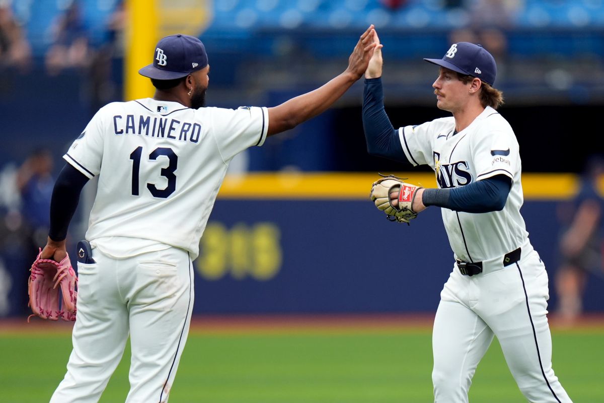 Tampa Bay Rays third baseman Junior Caminero (13) and right fielder Jonny DeLuca celebrate after the team defeated the Toronto Blue Jays during a baseball game Wednesday, May 6, 2026, in St. Petersburg, Fla. (AP Photo/Chris O'Meara)