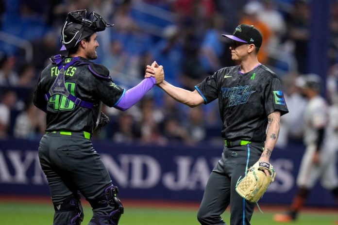 Tampa Bay Rays pitcher Casey Legumina, right, celebrates with catcher Nick Fortes after closing out the San Francisco Giants during a baseball game Saturday, May 2, 2026, in St. Petersburg, Fla. (AP Photo/Chris O'Meara)