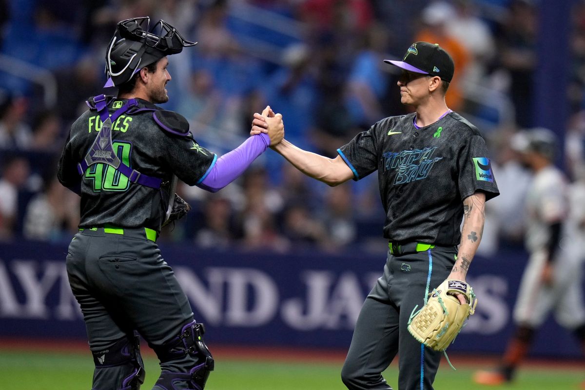 Tampa Bay Rays pitcher Casey Legumina, right, celebrates with catcher Nick Fortes after closing out the San Francisco Giants during a baseball game Saturday, May 2, 2026, in St. Petersburg, Fla. (AP Photo/Chris O'Meara)