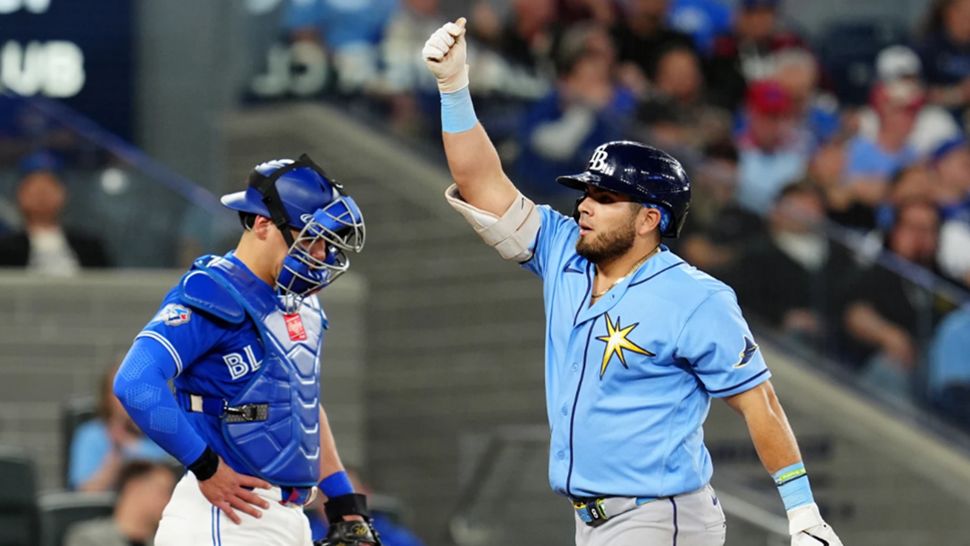 Toronto Blue Jays catcher Brandon Valenzuela, left, looks on as Tampa Bay Rays' Jonathan Aranda, right, celebrates after hitting a solo home run during fifth-inning baseball game action in Toronto, Monday, May 11, 2026. (Frank Gunn/The Canadian Press via AP)
