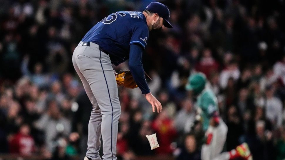Tampa Bay Rays pitcher Jesse Scholtens drops the rosin bag while preparing a fresh baseball as Boston Red Sox's Ceddanne Rafaela, right, rounds the bases on a solo home run in the fourth inning during a baseball game against the Tampa Bay Rays, Friday, May 8, 2026, in Boston. (AP Photo/Charles Krupa)