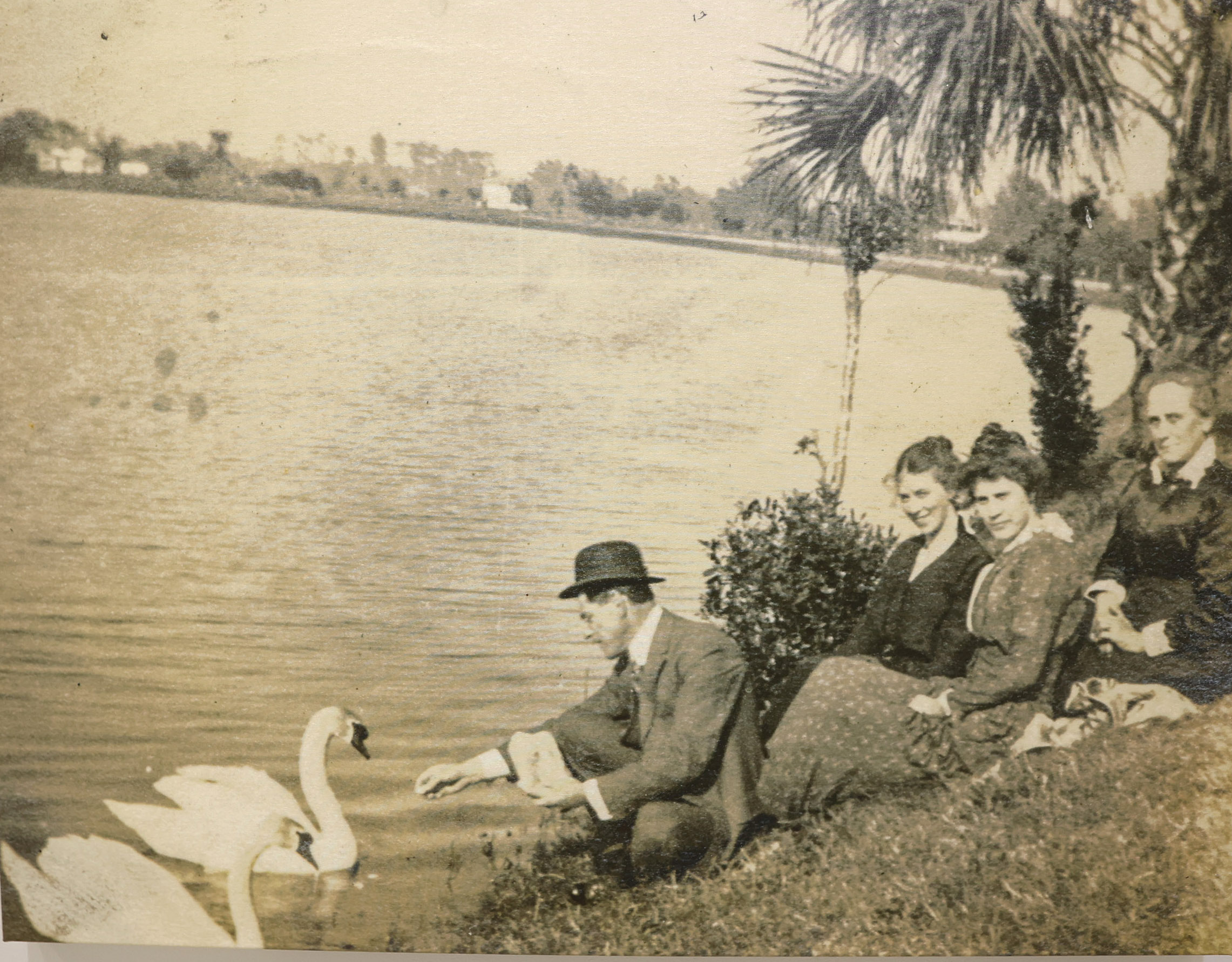 People feed swans on Lake Eola in 1910. (City of...
