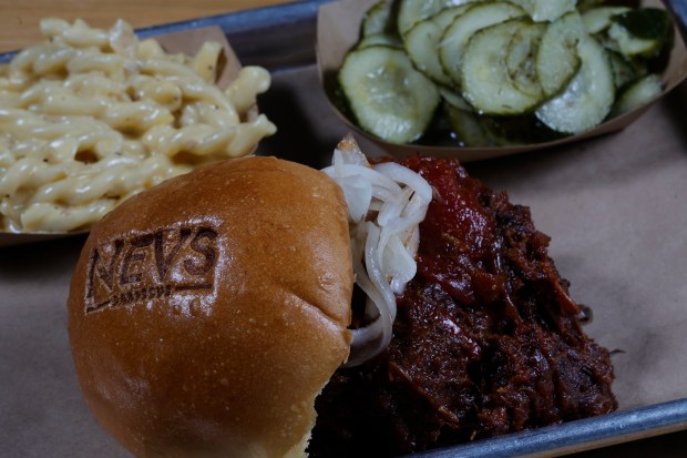 A USDA Prime brisket burnt ends sloppy joe with homemade pickles and mac and cheese is served at NEVS Barbecue in Palm Beach Gardens on Thursday, May 7, 2026. The restaurant was featured recently on "Diners, Drive-Ins and Dives." (Joe Cavaretta/South Florida Sun Sentinel)