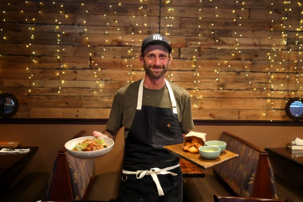 Jimmy Everett with the pork jowl fried rice and fried chicken oysters at his Driftwood restaurant in Boynton Beach on Saturday, May 2, 2026. The next Food Network airing on May 8 will feature Driftwood, along with Alaina's Cafe and Bake Shoppe in Palm Beach Gardens and Nev's Barbecue in Palm Beach Gardens. (Mike Stocker/South Florida Sun Sentinel)